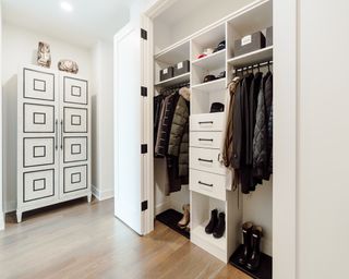 foldaway doors on a closet used as a mudroom with storage - Neat Little Nest