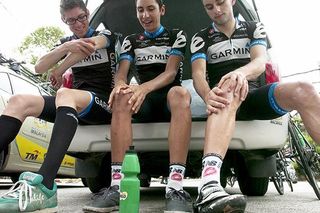 Riders from the Chipotle Development Team apply the sunscreen before the stage start, although the heavens opened up for the majority of the stage.