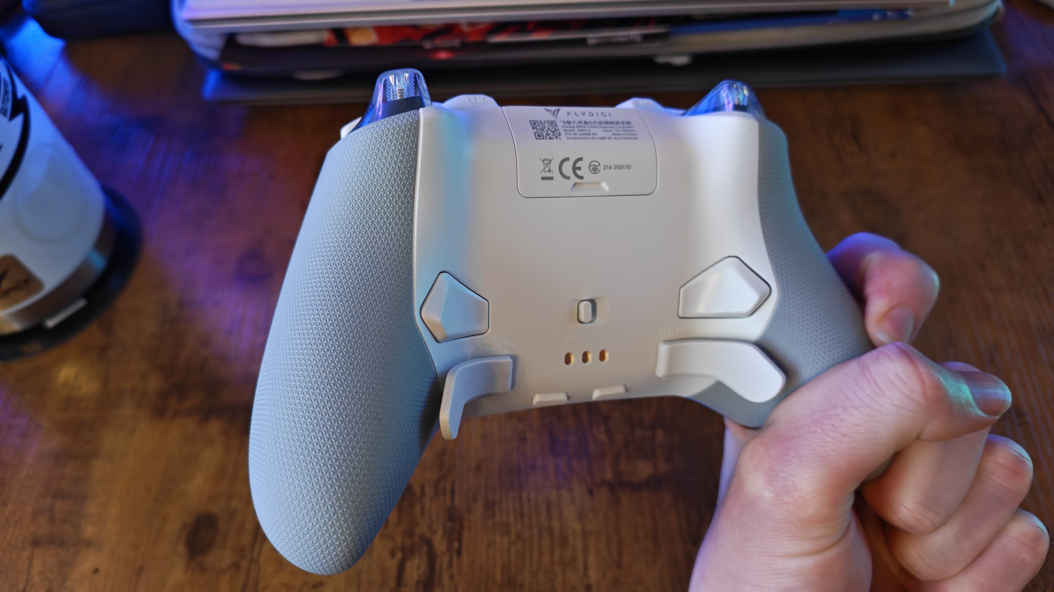 A reviewer showcasing the back buttons and back paddles on the Flydigi Apex 5