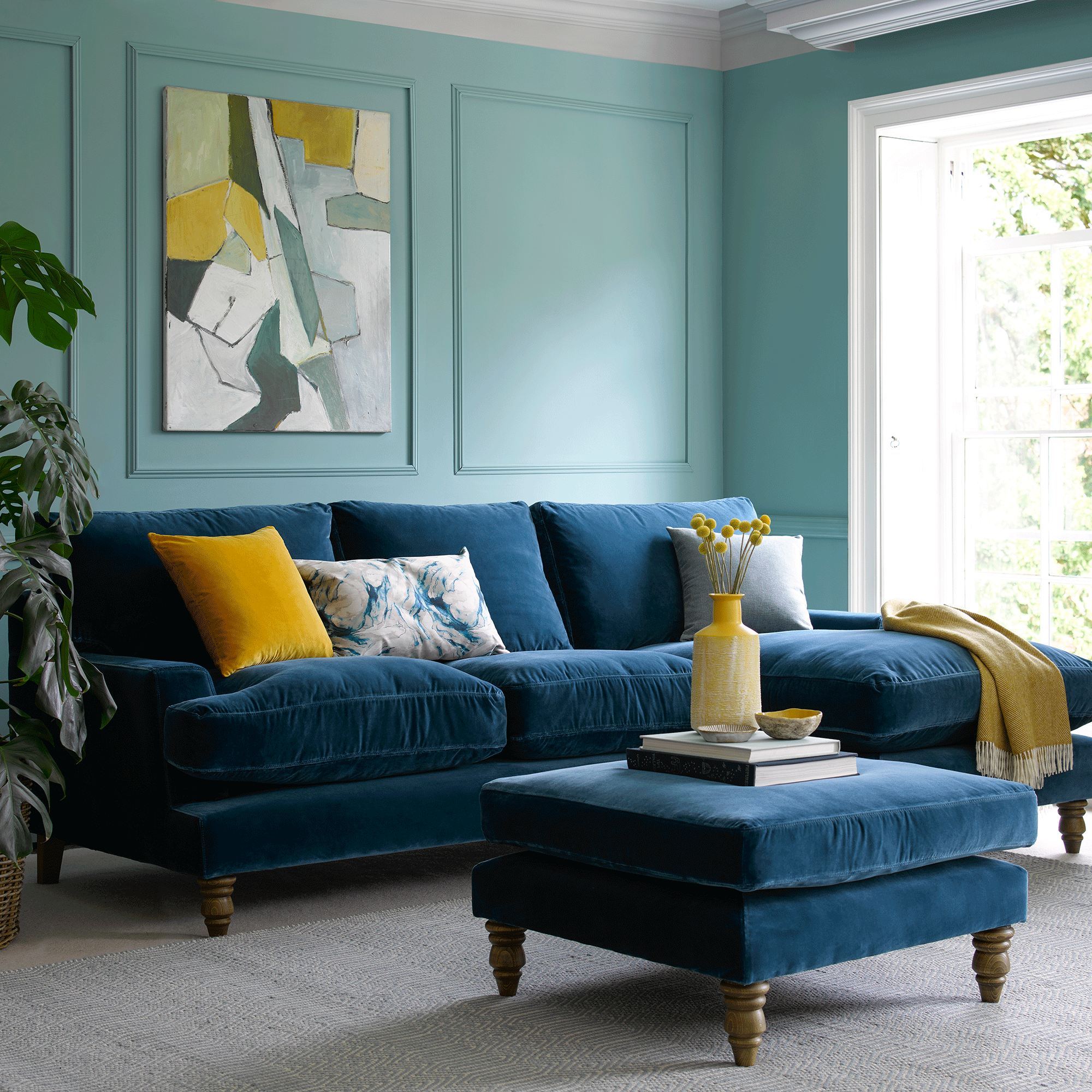 Blue sofa in blue room with large artwork