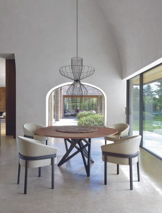 dark pendant light in dining area with vaulted ceiling