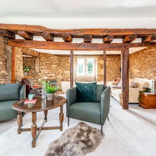 living room with wooden beams and sheepskin rug