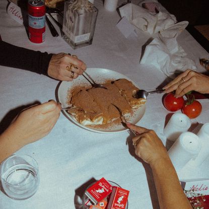 Women sharing a plate of tiramisu