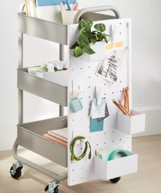 White pegboard attached to a storage cart