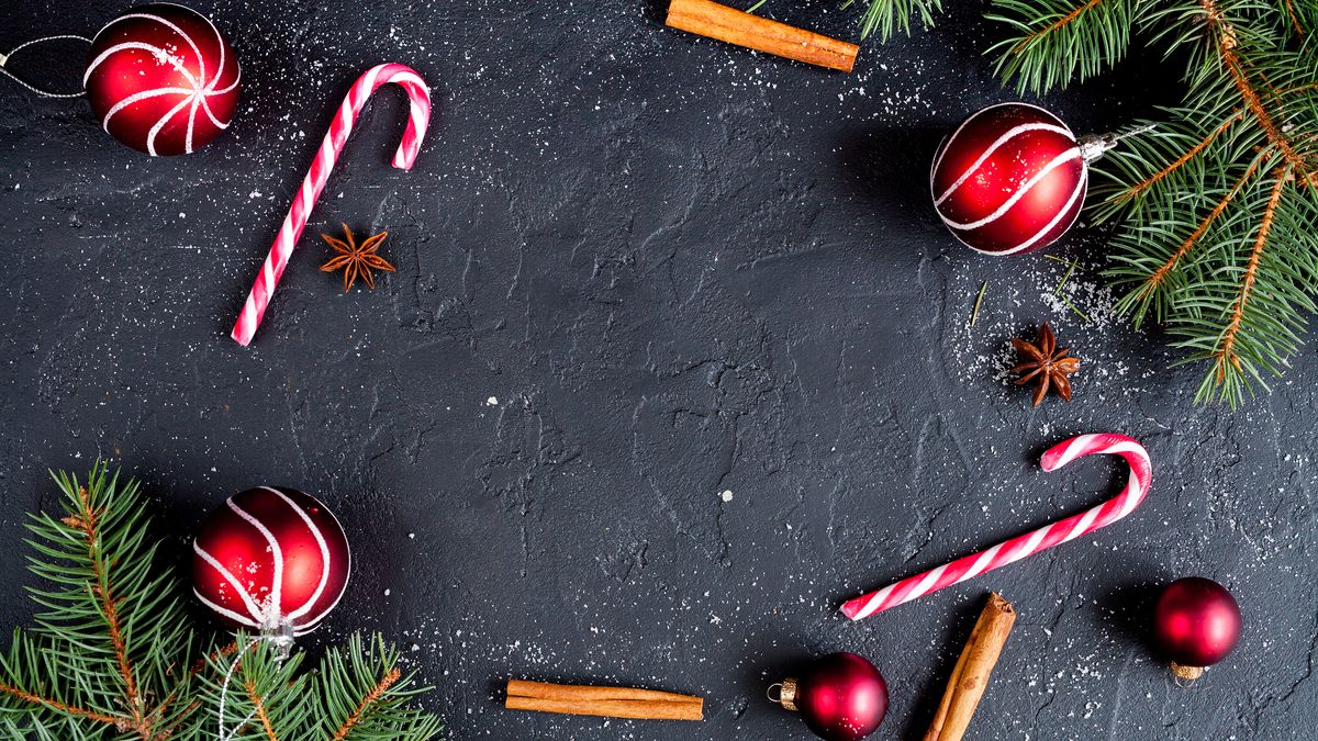 Christmas baubles and a Christmas tree on a slate background