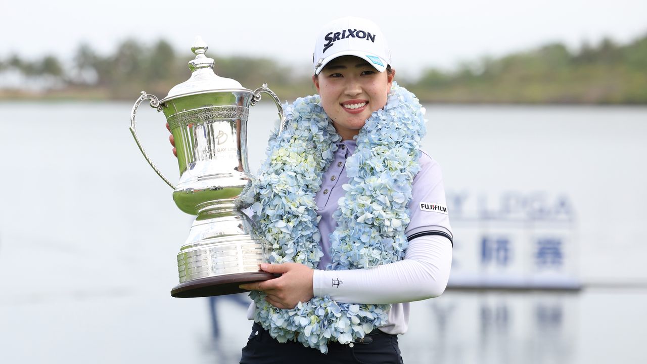 Japan&#039;s Rio Takeda holds up the Blue Bay LPGA trophy after winning in 2025