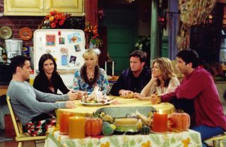 joey monica phoebe chandler rachel and ross sit around monica's kitchen table in friends