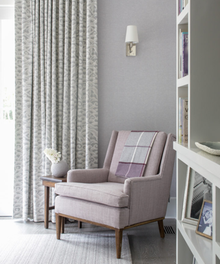 A light purple armchair in a neutral-toned room
