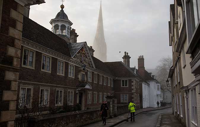 Salisbury Cathedral emerges from a morning fog in town centre