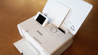 Epson PictureMate PM-400 Wireless Photo Printer being tested in writer's home