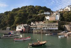 North Devon property, England, UK. Coastal scene with boats in the harbour below the village on a steep hillside