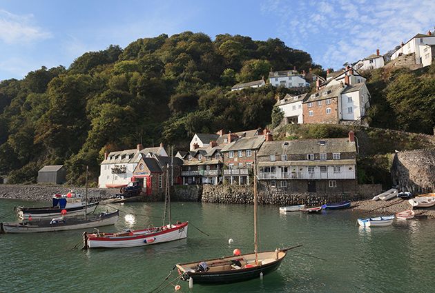 North Devon property, England, UK. Coastal scene with boats in the harbour below the village on a steep hillside