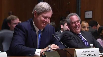 Agriculture Secretary Tom Vilsack tries not to crack up at Sen. Pat Roberts' cellphone ringtone