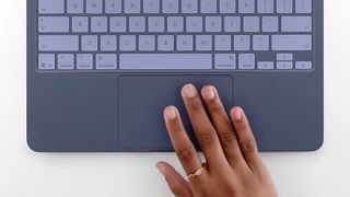 A person using the trackpad of the Apple MacBook Neo.