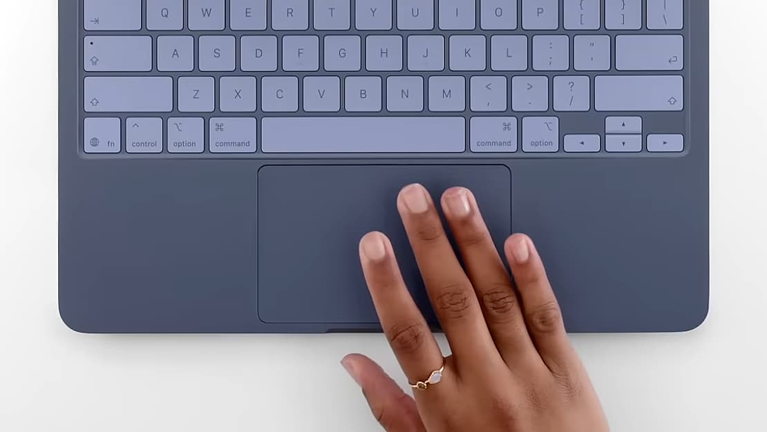 A person using the trackpad of the Apple MacBook Neo.