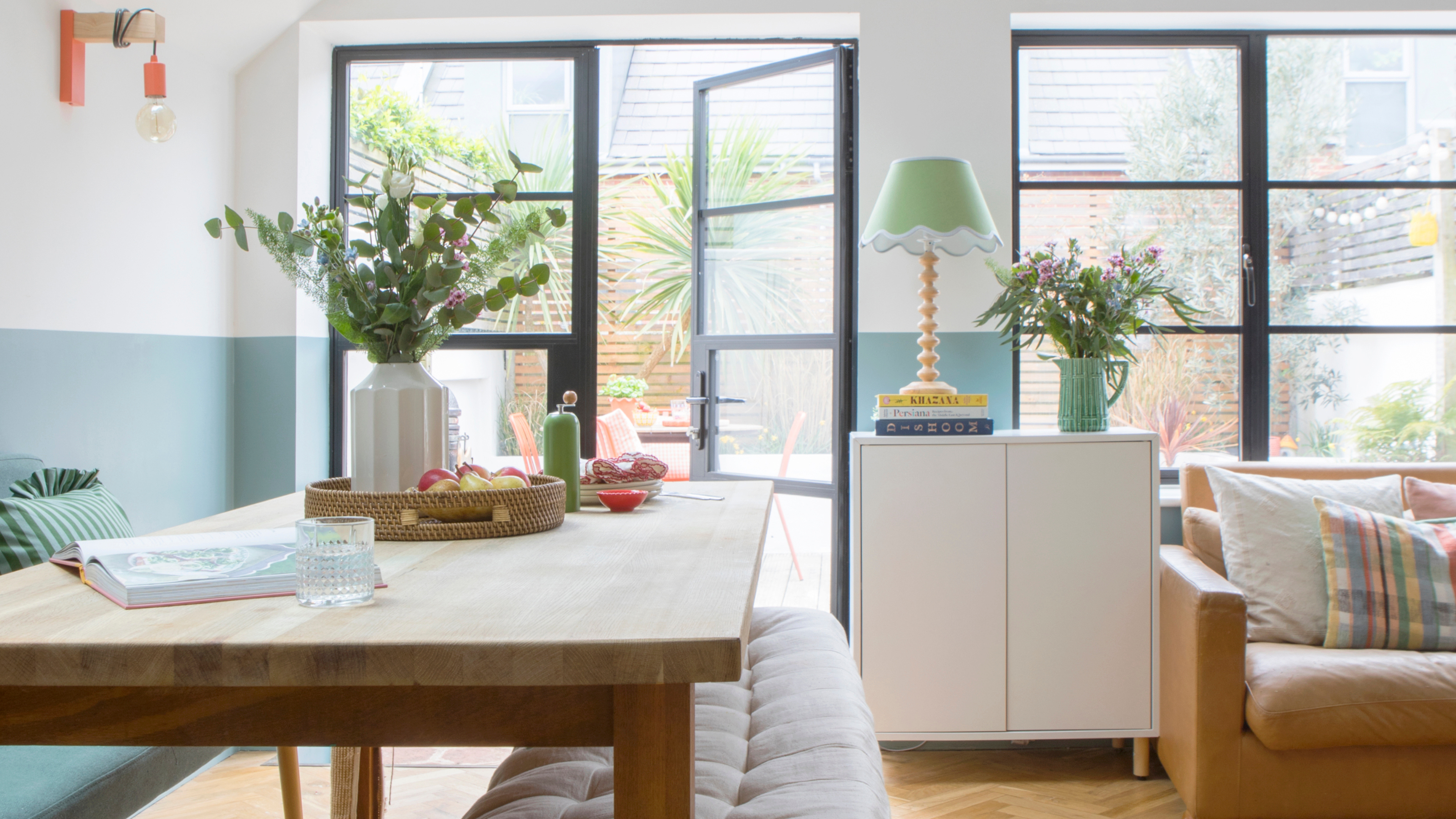 Mordern kitchen with glass doors open to the courtyard garden.