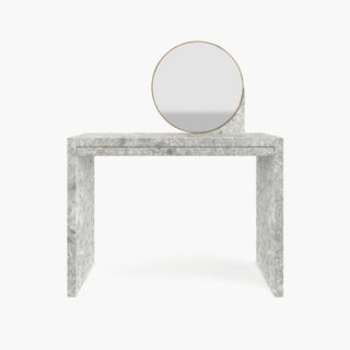 A minimalist marble vanity with round mirror