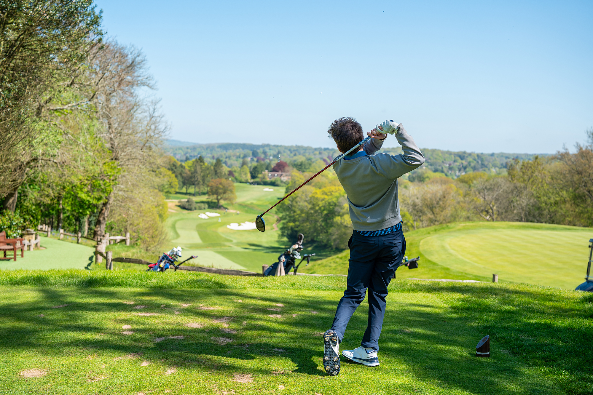 Dan Parker in the finish position with driver after hitting a tee shot on the 14th hole at Tandridge Golf Club