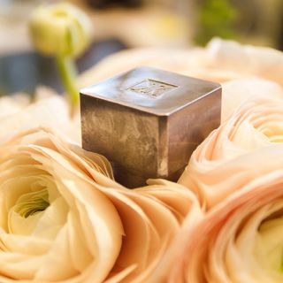 Perfume box laying on peach coloured roses