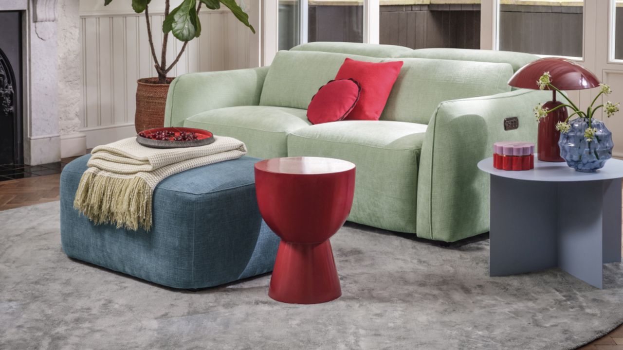 Sofology The Serene in sage green in a living room with red accessories