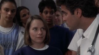 Amy Ryan looking up, talking to George Clooney in ER