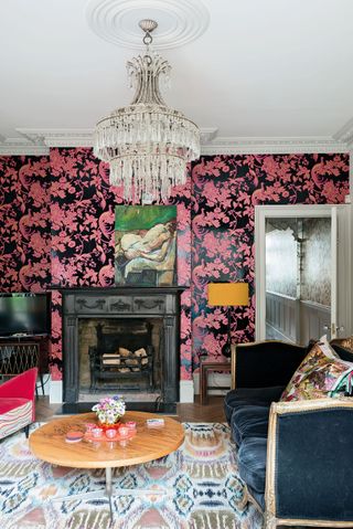 Living room with pink and black wallpaper and vintage furniture