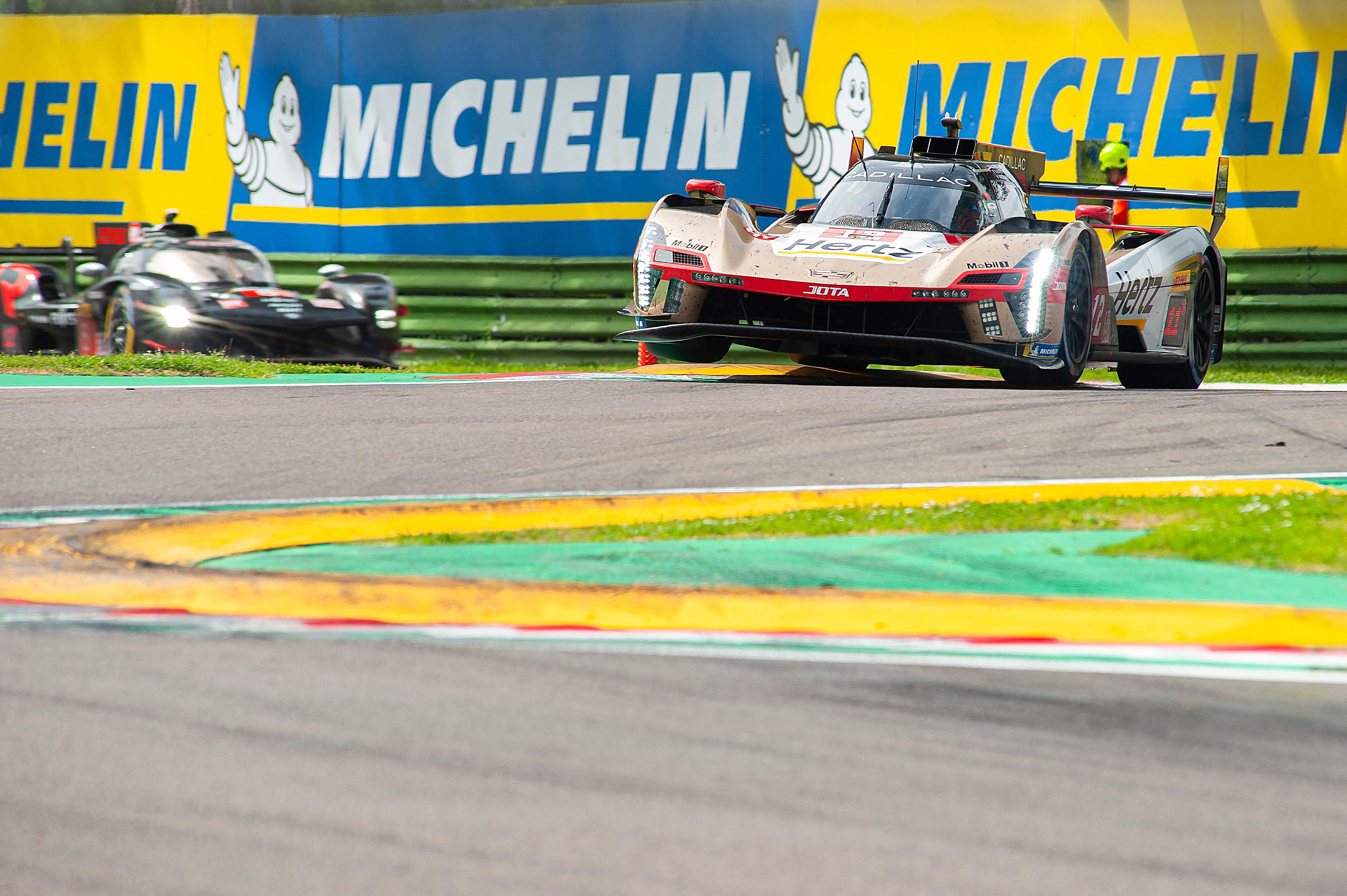 A Cadillac Hertz Jota car bumps off an Apex at a race