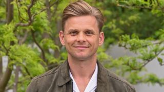 Jeff Brazier in a brown jacket.