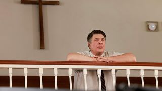 Lance Barber in a shirt and tie at church during Young Sheldon's penultimate episode.
