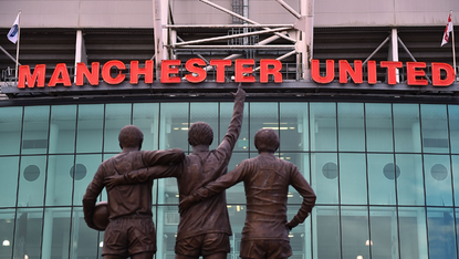 A statue of George Best, Denis Law and Bobby Charlton standing outside Old Trafford, home of Manchester United