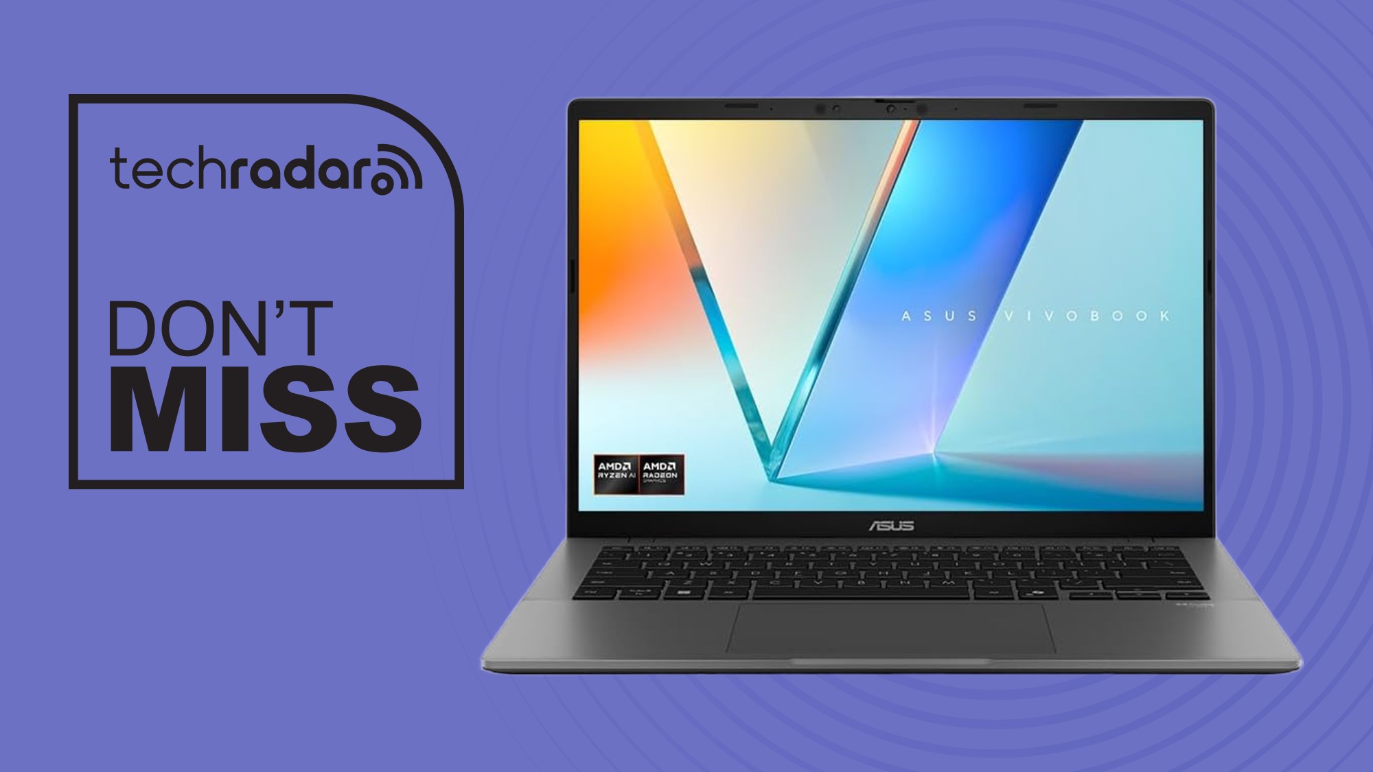 An ASUS Vivobook S14 laptop on a purple background next to a TechRadar badge that reads 'Don't Miss'
