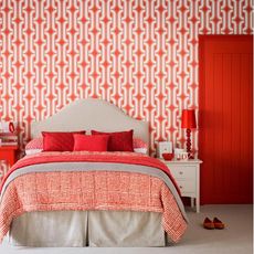 bedroom with red wallpaper and red bed accessories