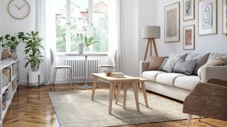 pale grey living room with large jute rug under coffee table and sofa to show styling trick for how to make a small living room look bigger