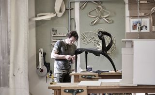 Walsh at work in his studio, crafting an ‘Enigmum’ chair