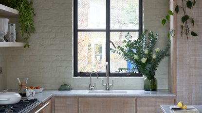 Blue kitchen with large island and gold pendant lighting