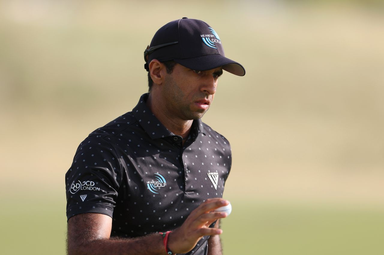 Aaron Rai waves to the crowd after holing a putt