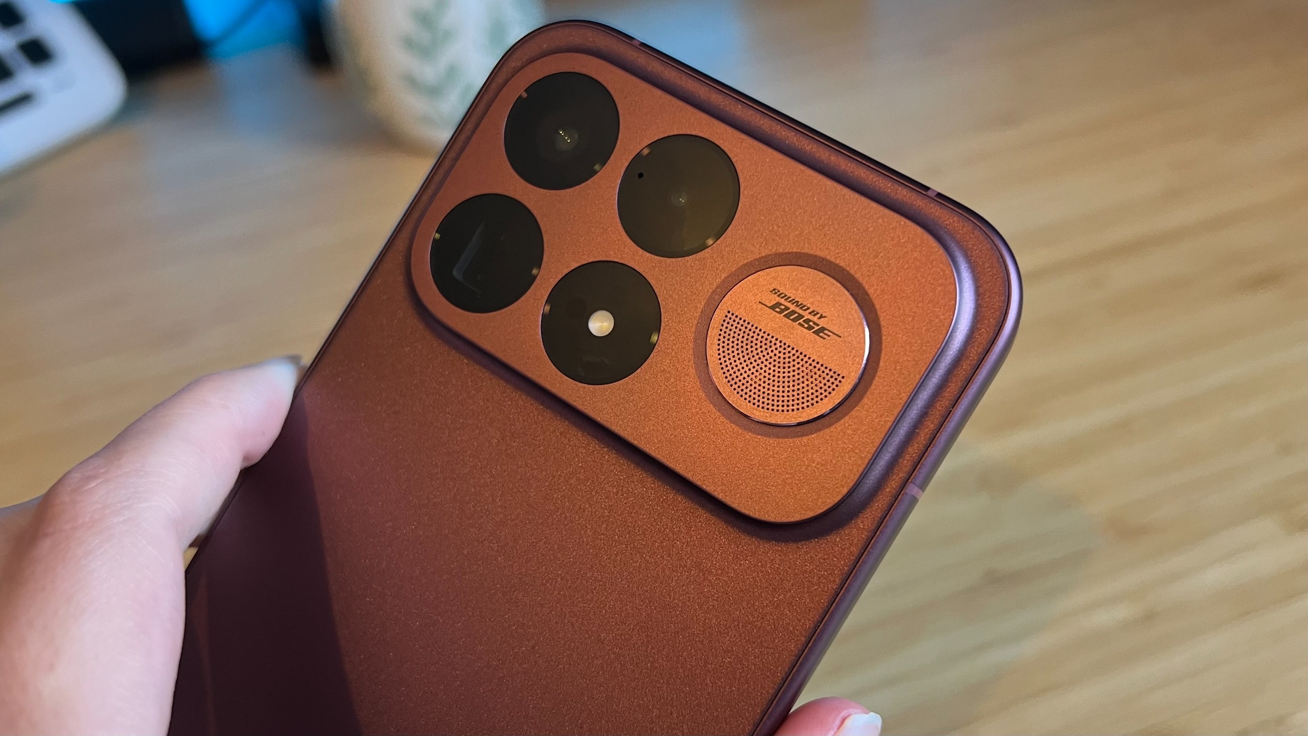Close up on camera and speaker on the back of the Poco F9 Ultra while being held in the hand