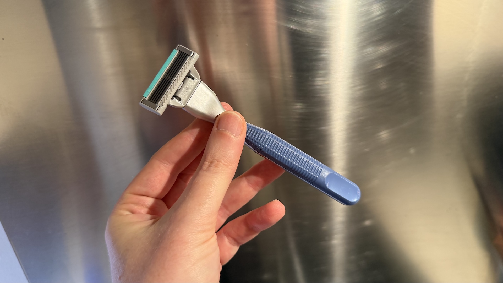 The Harry&#039;s Plus Razor against a stainless steel background