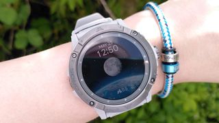 Coros Vertix 2S watch on woman's wrist showing home screen with moon graphic