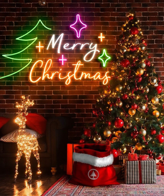 A Christmas tree and light-up reindeer with a neon Merry Christmas sign decoration