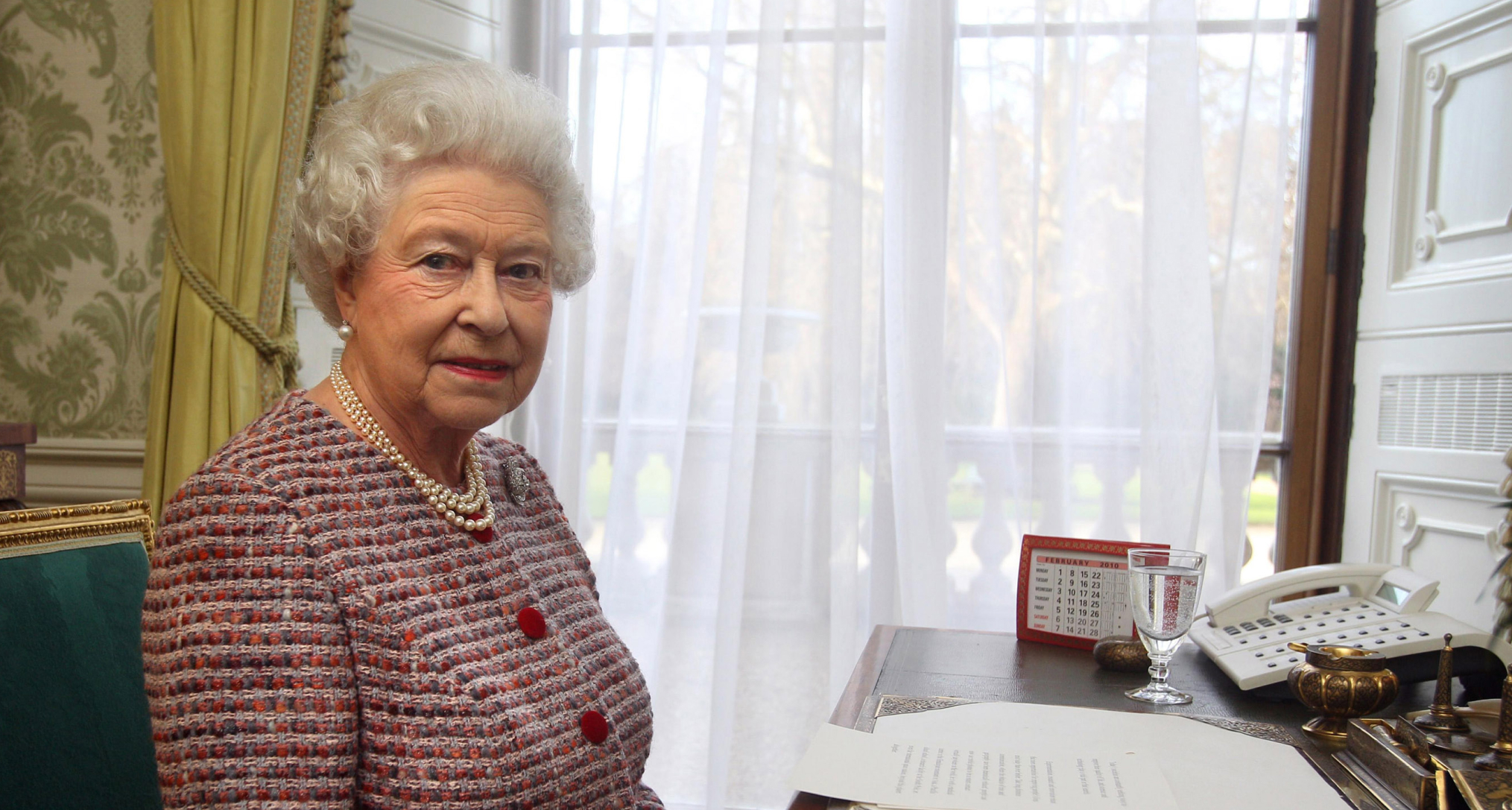 Queen Elizabeth sitting at a desk