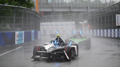 The Jaguar of Sam Bird leads the pack through a wet corner at the Formula E race in London