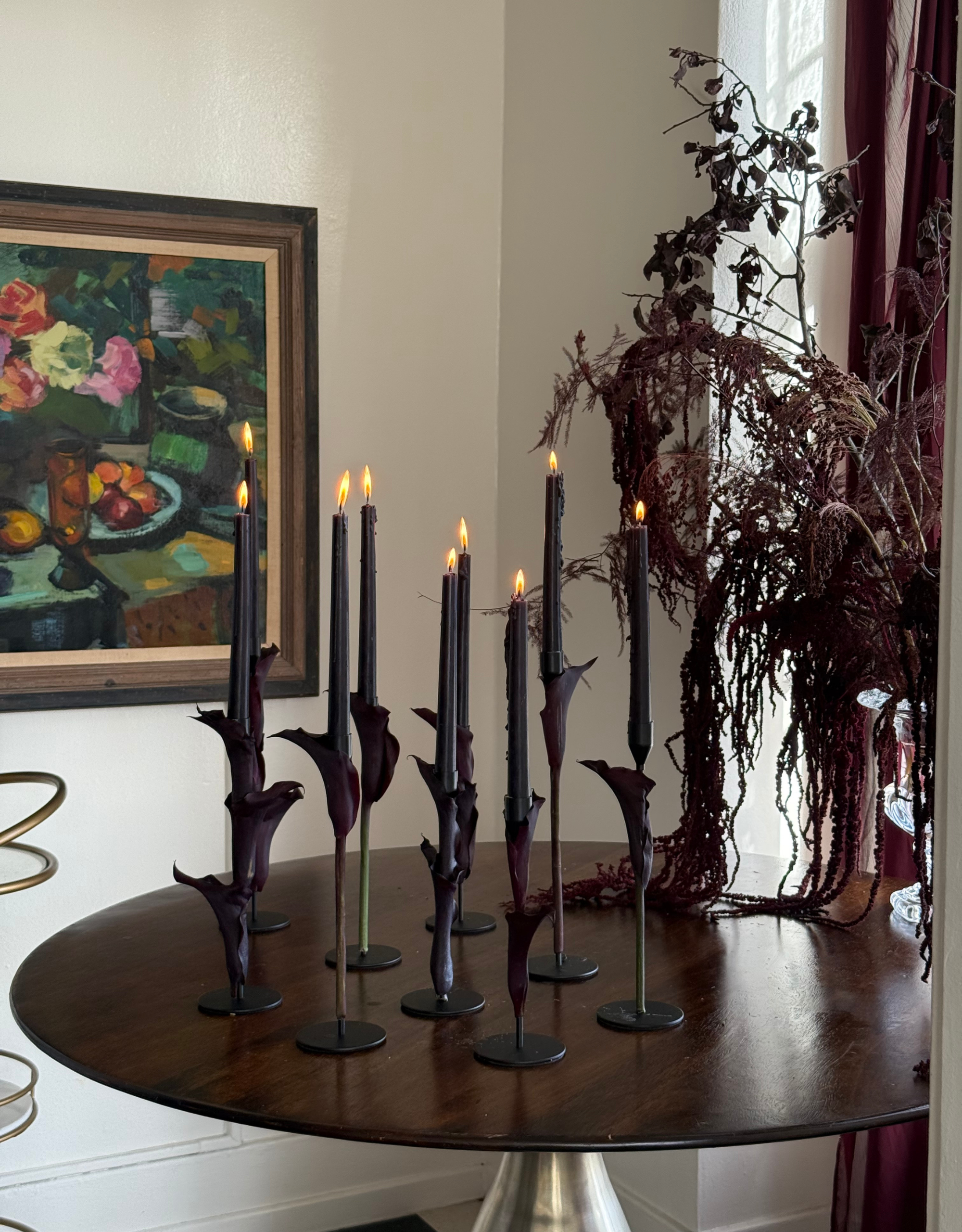 A table set with dark purple calla lily candlesticks