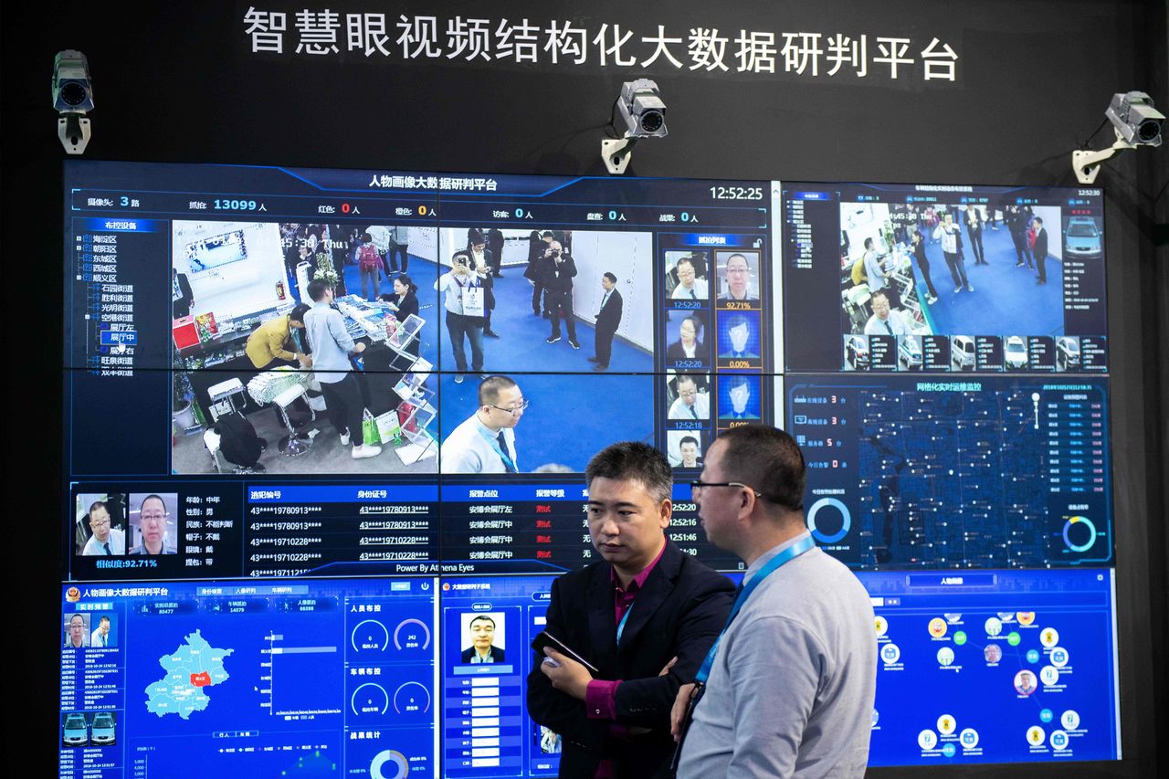 Visitors are filmed by AI (Artificial Inteligence) security cameras using facial recognition technology at the 14th China International Exhibition on Public Safety and Security at the China I