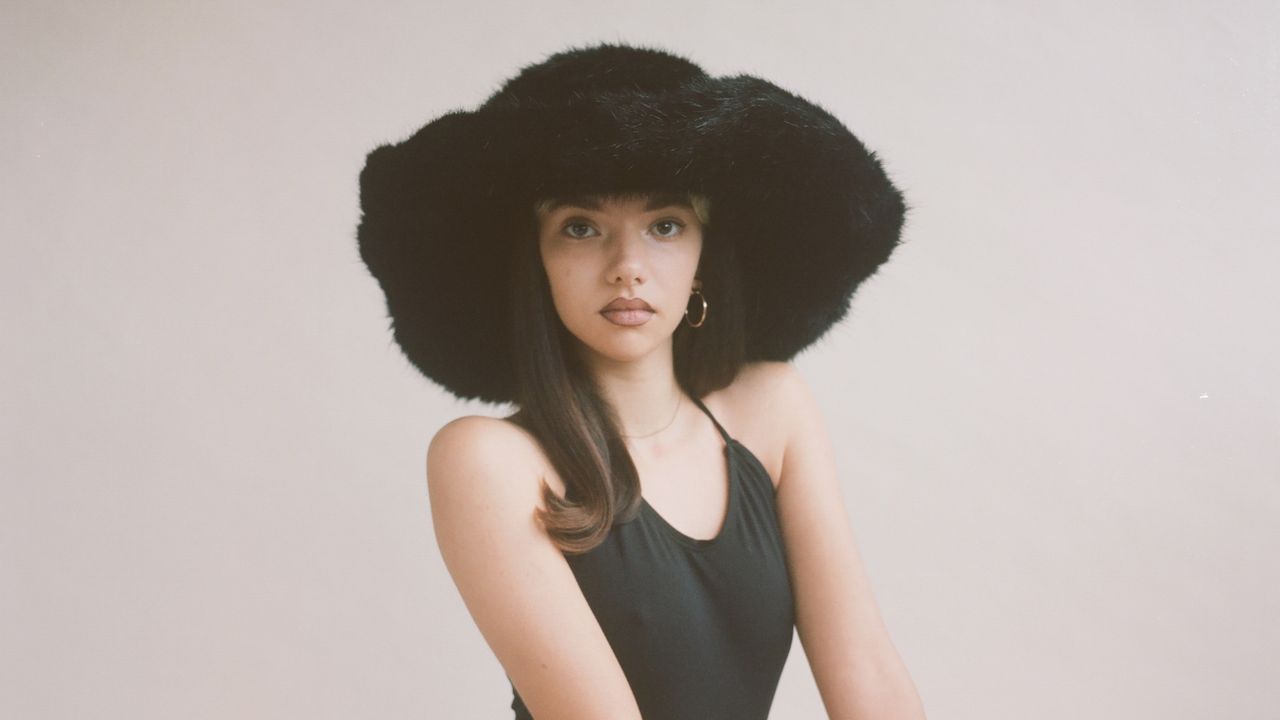 model wearing an Emma Brewin fuzzy bucket hat