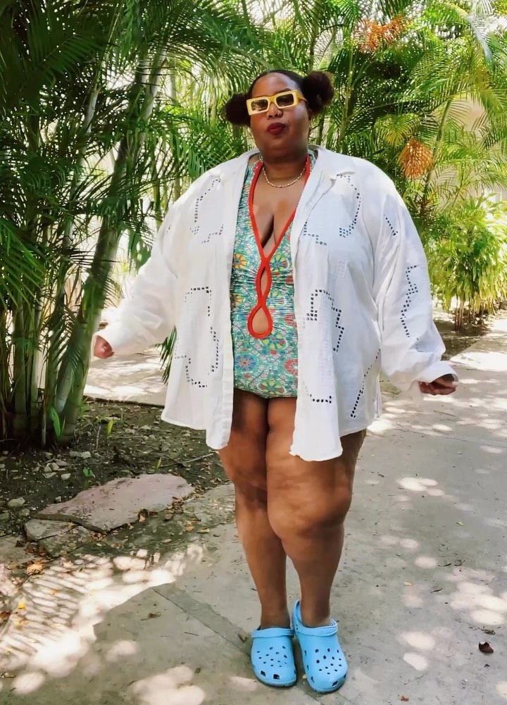 Kellie in blue crocs, white shirt, and swimsuit