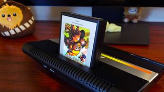 Atari 7800+ sitting on desk with cartridge in slot