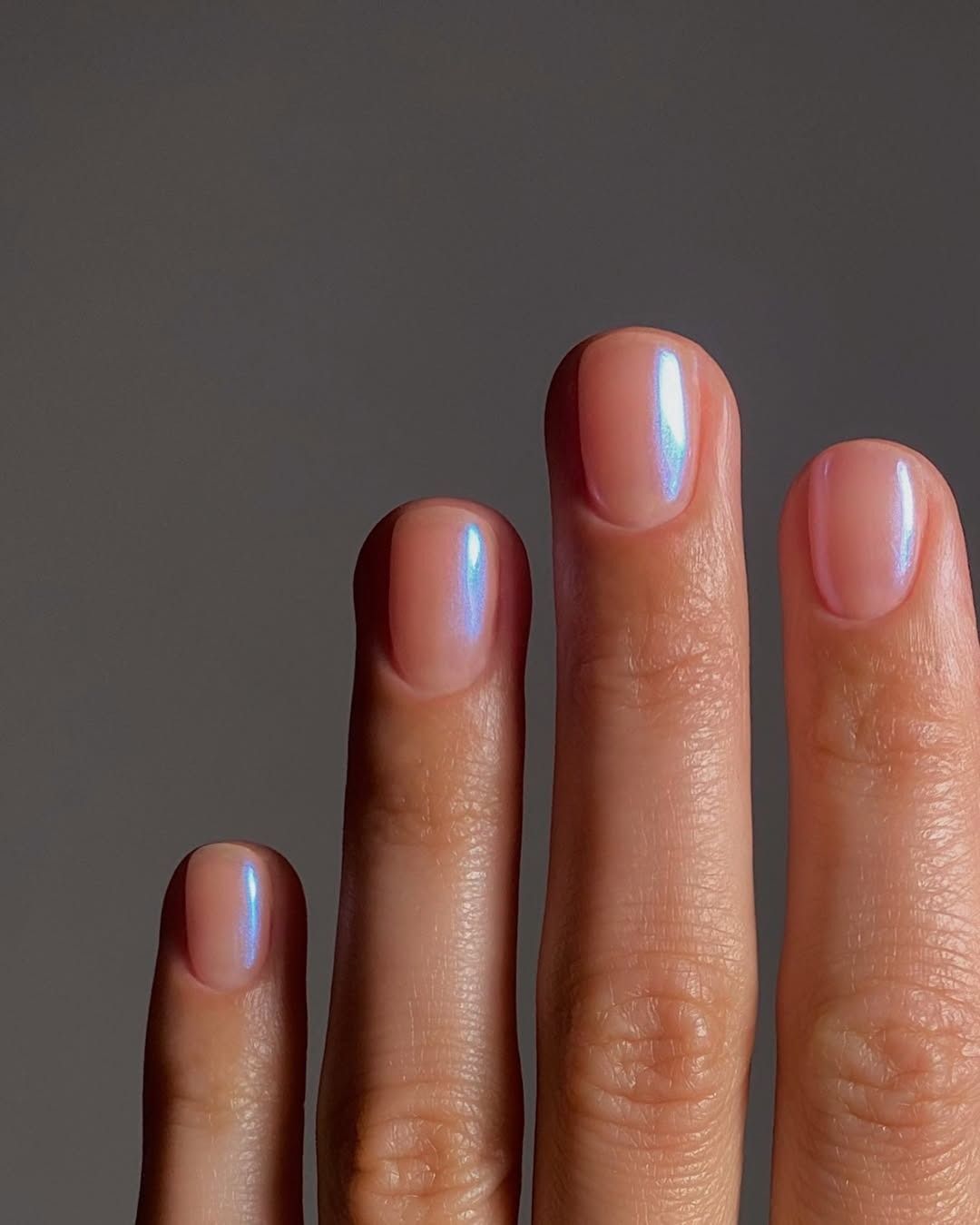 A sheer manicure with blue chrome powder