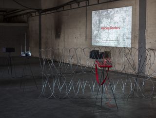 Installation Voicing Borders by Irakli Sabekia, featuring razor wire in a bare room