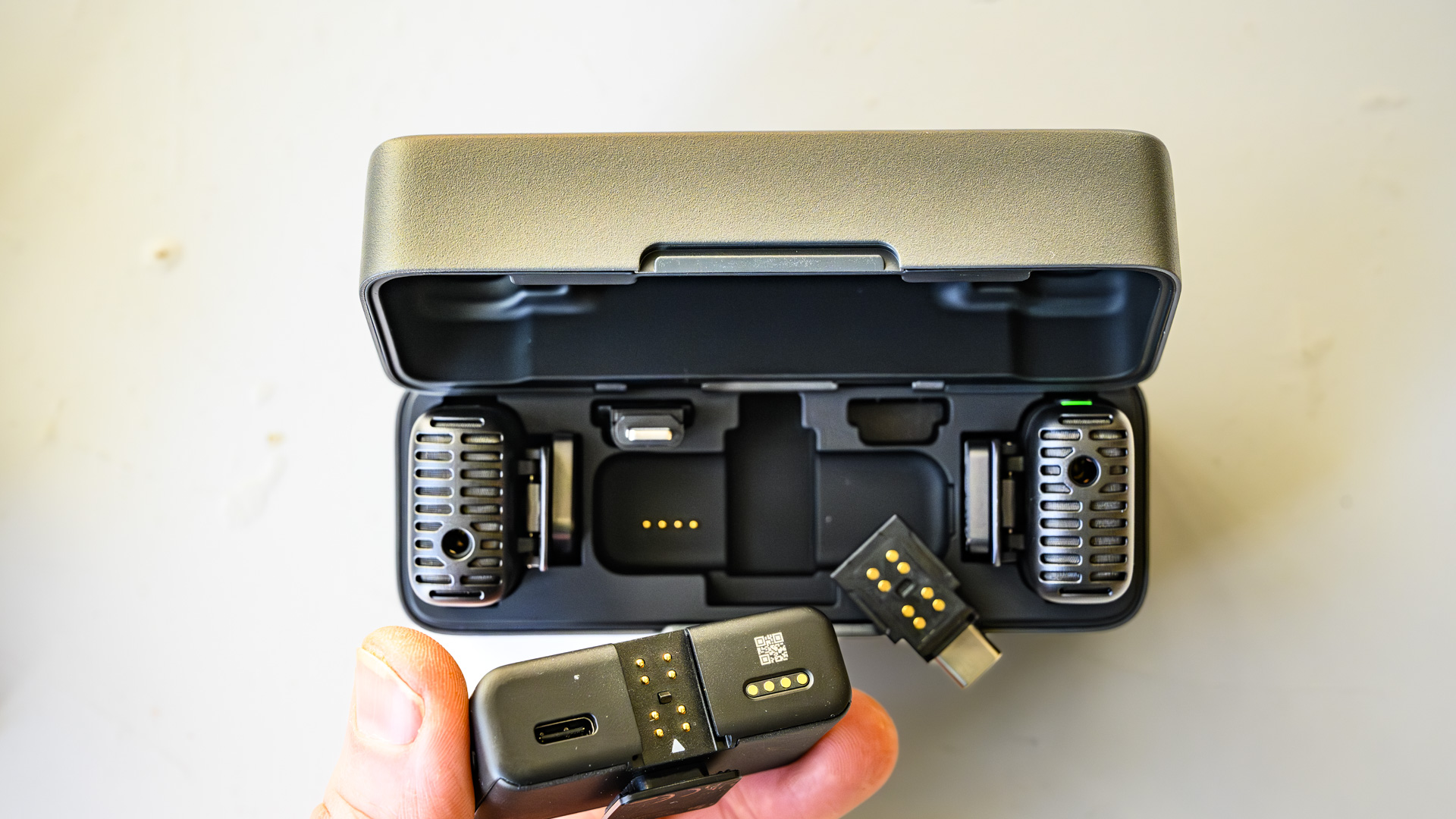 DJI Mic 2 charging case from above with lid open and receiver removed